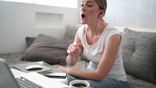 Woman Video Chatting on Laptop at Home