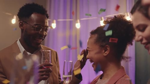 Friends celebrating with champagne and confetti at party