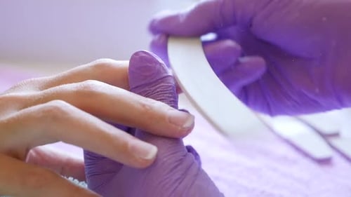 French manicure process done by professional in salon 1080p HD slow motion footage - Sandpaper nail