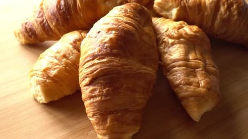 Golden Brown Croissants on a Wooden Table