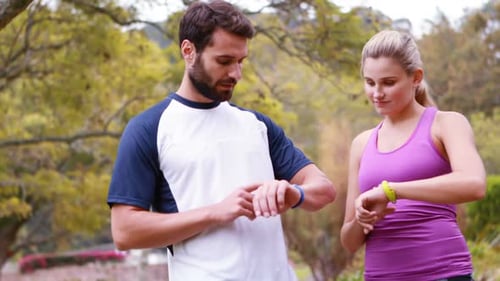 Couple checking a time in forest