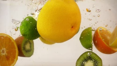 Halves of Different Fruits Falling with Splashes in Water, Multifruit Set, Slow Motion Close-up