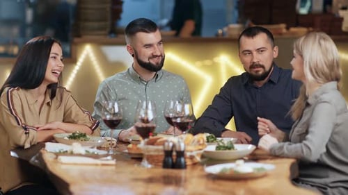 Friends Gathering for Dinner at Urban Restaurant