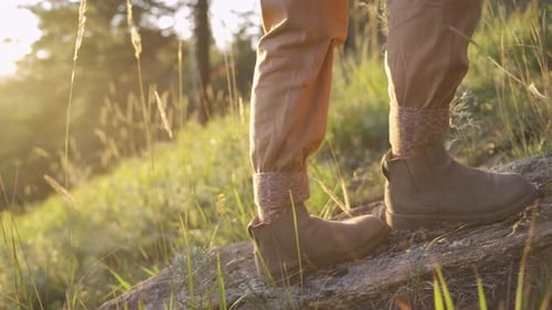 Legs and Boots Walking Up Rocky Hillside