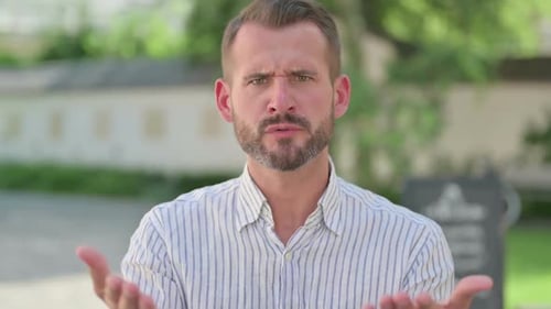 Adult Man Talking and Gesturing to Camera