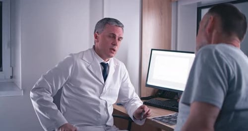 Doctor Consults with Patient in Office