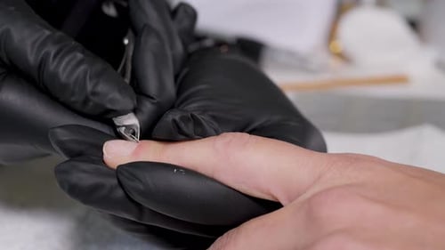 Close Up Macro Finger Nail Care By Manicure Specialist in Beauty Salon. Manicurist Clear Cuticle