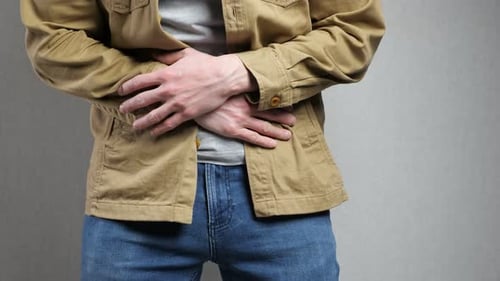 Man Holding Stomach in Pain