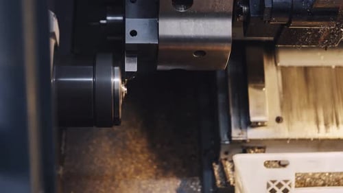Closeup Automated Cnc Turning Lathe Machine Cutting Metal Part at Factory