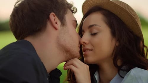 Attractive Girl and Guy Showing Feelings in Park. Couple Touching Noses Outdoors