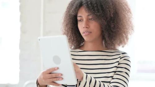 Woman Using Tablet Device Indoors