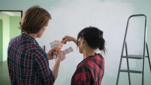 Young Couple Choosing Paint Colors for Home