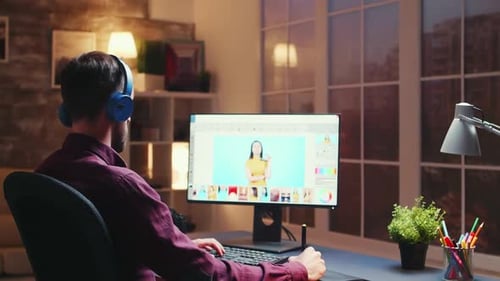 Young Adult Editing Photos at Home at Night