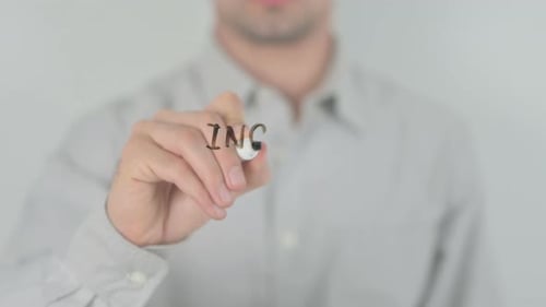 Man Writing Income Inequality with a Marker