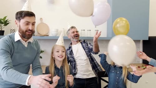 Happy Family Celebrating Birthday with Balloons and Cake