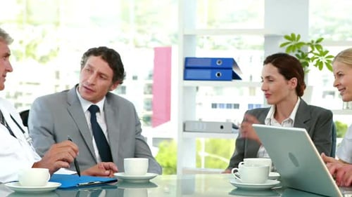 Medical Professionals and Business People Meeting at Table