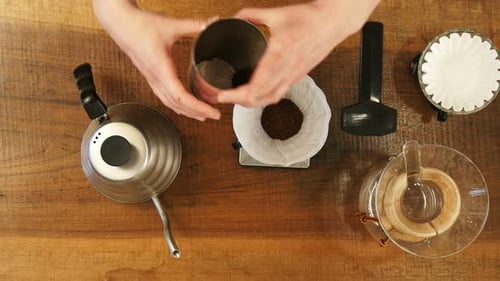 Hand Drip Coffee , Barista Pouring Water on Coffee Ground with Filter