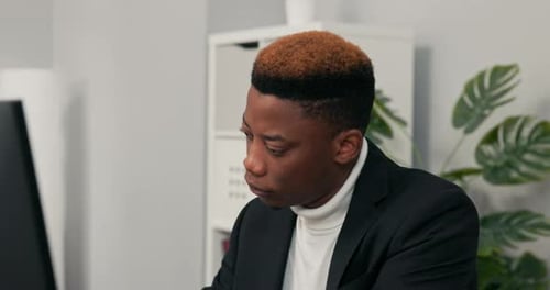 A Closeup of Face of Darkskinned Man Working in an Office Law Firm Boy is Sitting Behind Desk in