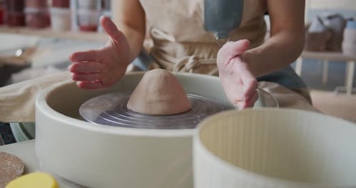 Female Potter Shapes Piece of Clay on the Pottery Wheel.
