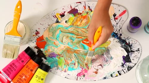 Mixing Colorful Paints on Artist's Palette With Brush