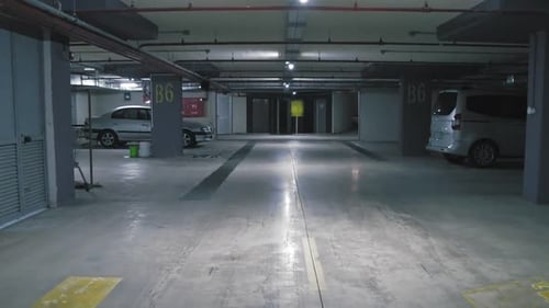 Empty Parking Garage at Night with Fluorescent Lighting