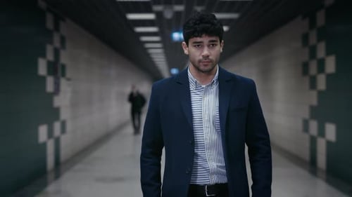 Confident Man in Business Outfit Walking in Subway Station