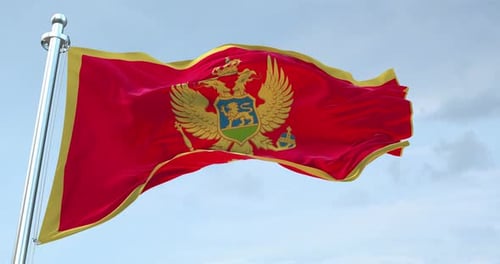Montenegro Flag Waving on Flagpole against Cloudy Sky