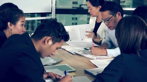 Asian Business People Discuss Marketing Strategy