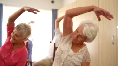 Seniors Exercising Together in an Indoor Class
