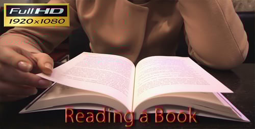 Woman reading book at a table