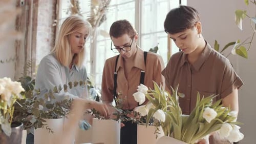 Mixed-Aged Team of Florists Making Flower Compositions in Workshop