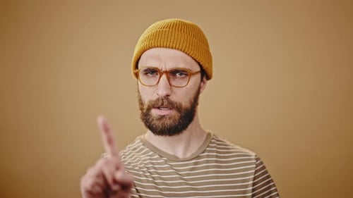 Brutal Hipster in Glasses Shows Disagreement Closeup