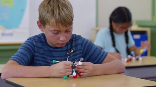 Children in school classroom building science models