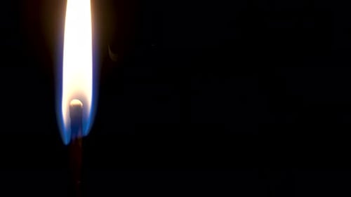 Close Up of Match Igniting in the Dark