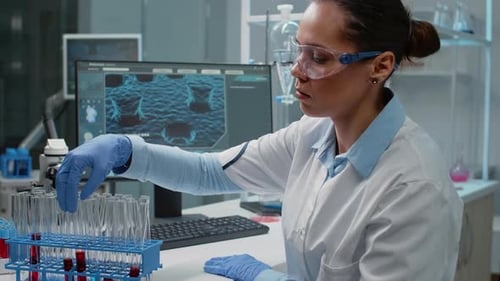 Medical Researcher Analyzing Test Tubes in Lab