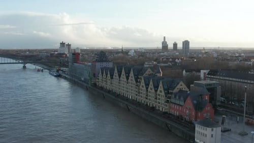 AERIAL: European Houses on River in Cologne Germany with Beautiful Sunlight