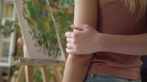 Two Young Lovely Girlfriends are Standing in the Studio and Drawing a Picture in Shades of Green