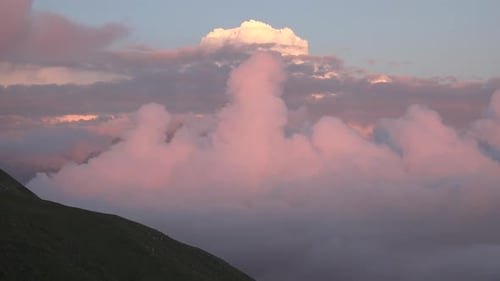 Beautiful Pink Clouds Moving Over Mountain Range