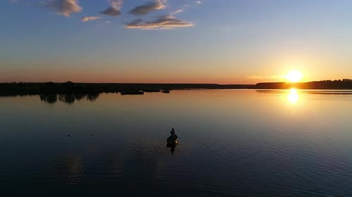 People in the Rowing Boat, Sunset on a Lake or River - Drone Footage