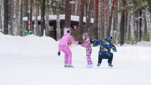 Parents Fall Down Onto Ice Rink Spending Time with Daughter