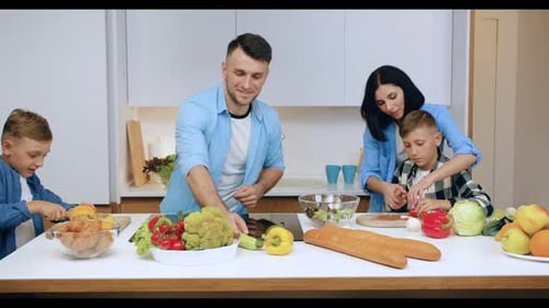 Family Prepares Food Together in Bright Kitchen