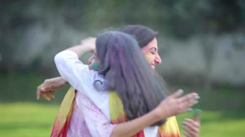 Woman and Child Celebrating Holi with Colorful Powder