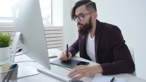 Designer Uses Graphics Tablet at Modern Desk
