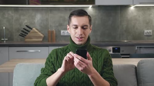 Man Using Phone in Modern Home Environment