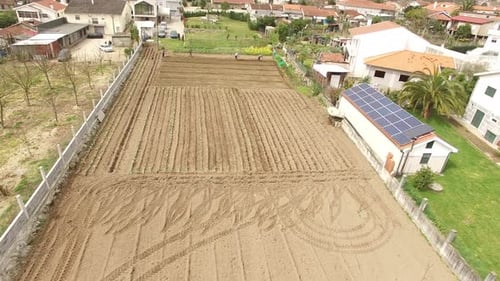 Aerial View of Workers Planting Crops in Field