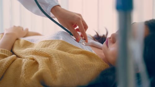 Doctor Examines Patient with Stethoscope in Hospital