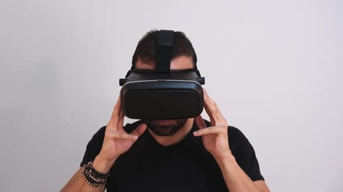 Man Adjusting Virtual Reality Headset Indoors