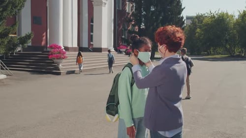 Woman Seeing Girl Off to School Amidst Pandemic