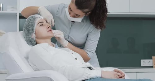 Woman Receives Lip Filler Injection in Medical Setting