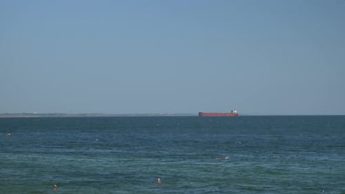 Large container ship in sea, time lapse. Bulk carrier ship is sailing in open ocean.